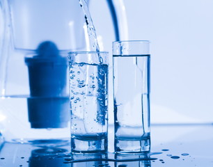 Drink. Water glass, filter, white background, water jet and droplets