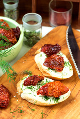 Sandwiches with dried tomatoes, cheese and greens.