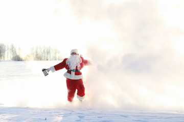 Santa in the winter field. Santa magical fog is walking along th