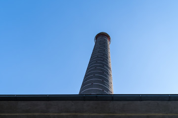 Factory chimney against a blue sky at the abandonned blast furnace at Duisburg Landschafts Park Germany
