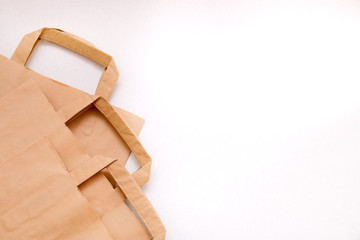 Three  paper bags of kraft paper on a white background, the theme of shopping