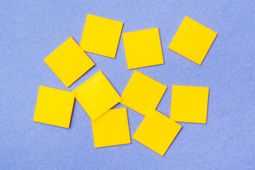 Yellow plastic flat squares are scattered chaotically on a blue background. Top View