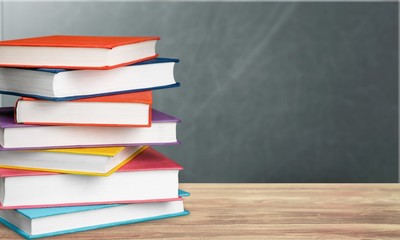 Colorful books collection on background.