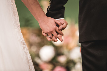 bride and groom holding hands