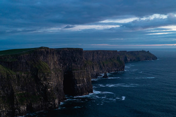 Fototapeta na wymiar The cliffs of moher during blue hour. The photo is moody.