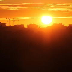 Cityscape with silhouette of city skyline against setting sun. Minsk, Belarus