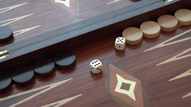 Rolling two dice on a Backgammon setting, the dice coming up as a 5 and a 6. Set of four different rolls.