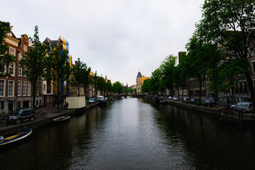 Fototapeta na wymiar Amsterdam, Netherlands - June 3, 2018: A view of a canal in Amsterdam