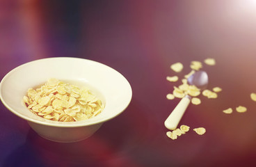 Corn flakes in a plate. Breakfast from flakes with honey and mil
