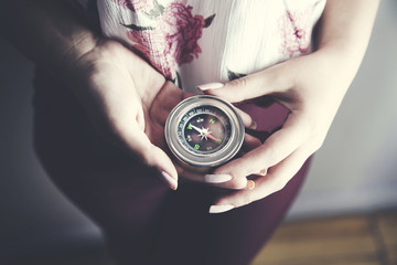Female hand holding compass © ARAMYAN