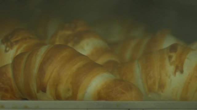 Time lapse traditional french croissants baking in oven.Closeup