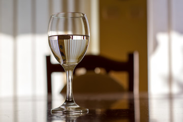 One Wine Glass. Close Up View. Abstract Brown Background.