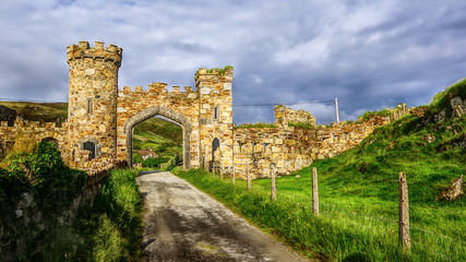 Fototapeta na wymiar Gate to the Castle Demesne. Mountainous coastal region in Galway, in western Republic of Ireland. HDR technique.