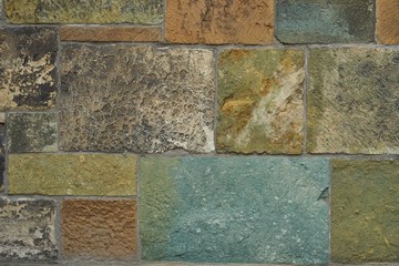 Decorative colored stone blocks at the outside wall of an old church.
