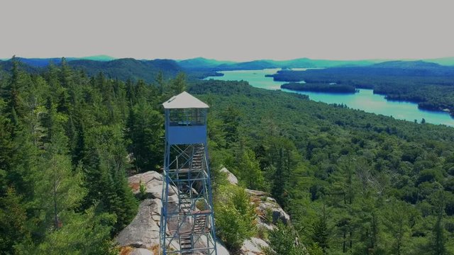 Aerial drone view of a fire tower in the Adirondack Mountains. 