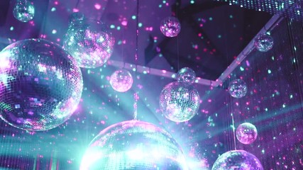 Beautiful mirror balls rotates under the ceiling. Night disco party concept