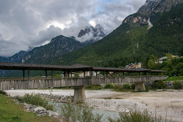 Obraz na płótnie Canvas Wooden bridge over mountain river