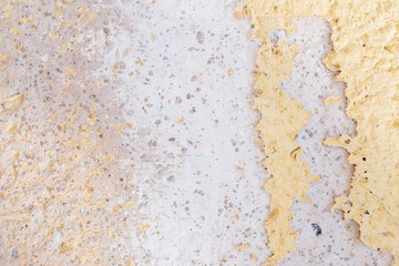 Old wall of yellow and white color with cracked paint. Great retro background