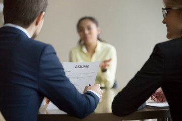 Businesswoman, businessman HR managers interviewing asian woman candidate in office. Boss holding...