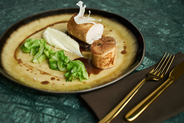 Goose galantine, mushroom fricassee, young cabbage and sauce. chicken sausage with baked green cabbage. Healthy diet food concept.