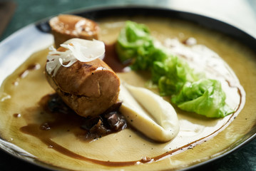 Goose galantine, mushroom fricassee, young cabbage and sauce. chicken sausage with baked green cabbage. Healthy diet food concept.