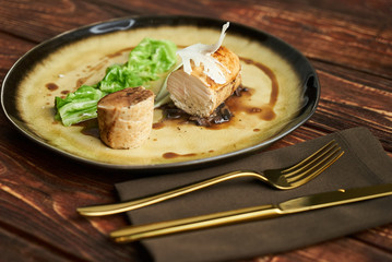 Duck galantine, mushroom fricassee, young cabbage and sauce. chicken sausage with baked green cabbage. Healthy diet food concept.