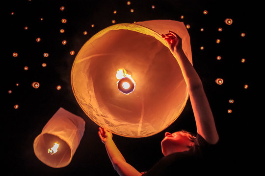 Young Tourist Woman Releasing A Sky Lantern On The Ye Peng Festival In Chiang Mai, Thailand