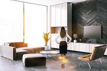 Businesswoman in loft modern living room interior
