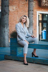 Young beautiful woman in the morning walking around the city in a jacket. Costume.