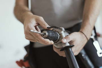 Professional handyman changing a drill bit