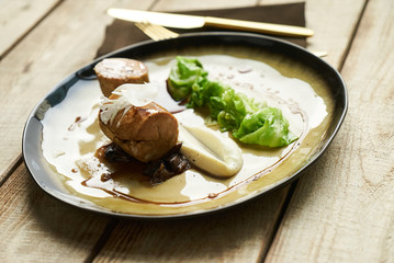 Goose breast galantine, mushroom fricassee, young cabbage and sauce. chicken sausage with baked green cabbage. Healthy diet food concept.