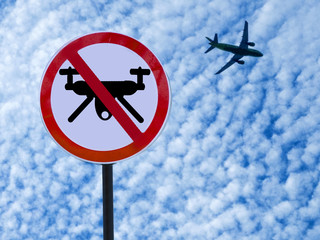 sign ban drones on sky background with clouds and taking off plane.