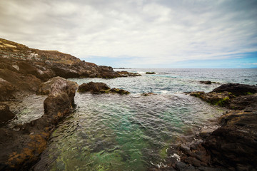 Tenerife, Canary islands, Spain - view of the beautiful Atlantic ocean coast with rocks and stones