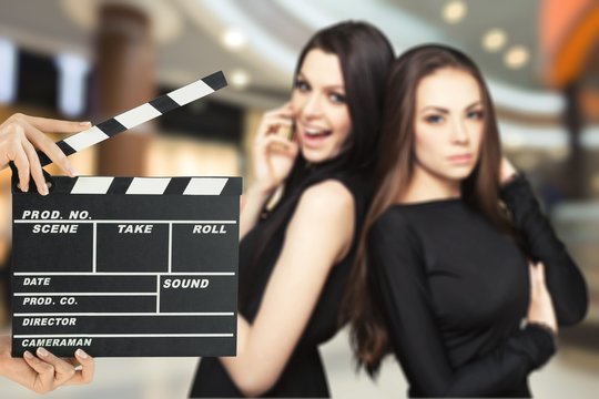 Attractive young women and clapper board