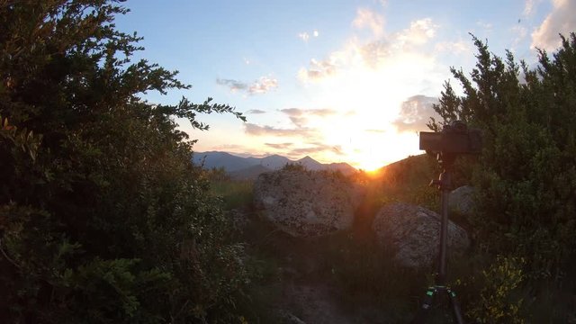 SLR camera on a tripod making a time lapse during a sunset in Pyrenees, France
