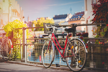 Vintage bike near railing on city street of Strasburg, France. Autumn season time