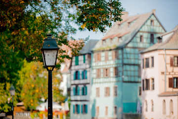 Vintage street lamp with near a tree in fall season. Strasburg, France