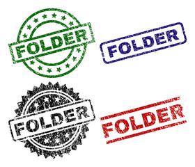 FOLDER seal prints with damaged surface. Black, green,red,blue vector rubber prints of FOLDER title with corroded surface. Rubber seals with circle, rectangle, medal shapes.