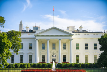 The White House in Washington, D.C. USA on a summer day with clouds forming overhead.