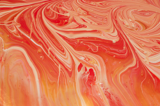 Photos of manufacturing a paint composite color. Mixing acrylic paint in different colors. Marbleized.