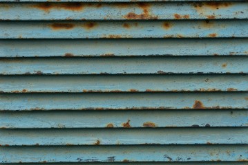 blue striped texture of metal from an old and rusty lattice