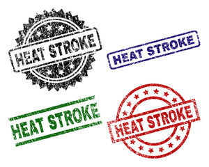 HEAT STROKE seal prints with damaged texture. Black, green,red,blue vector rubber prints of HEAT STROKE title with corroded texture. Rubber seals with circle, rectangle, medal shapes.