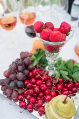 fruits and vegetables on the banquet table, strawberries, cherries, grapes, apples, pears