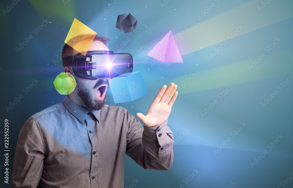 Poster amazed businessman with virtual reality colorful geometric shapes in front of him