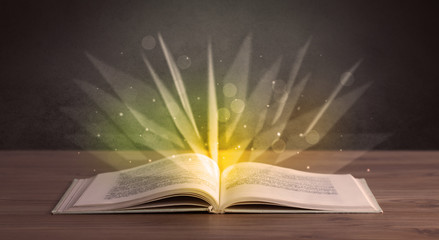 Yellow lights spreading from an open book 