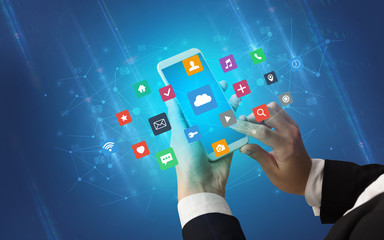 Female hand using smartphone with colorful application icons around