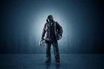 Bad agent in a dark room with arms on his hand and gas mask
