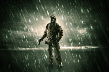 Terrorist in a stormy space with gas mask on his hand and weapons on his arm
