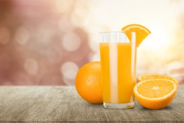 Orange juice and slices of orange on background