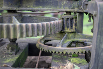 Old rusty gears. Gear wheels in agricultural equipment.